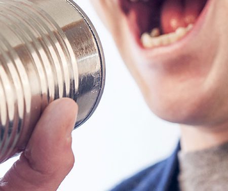 image of a man shouting into a tin can.