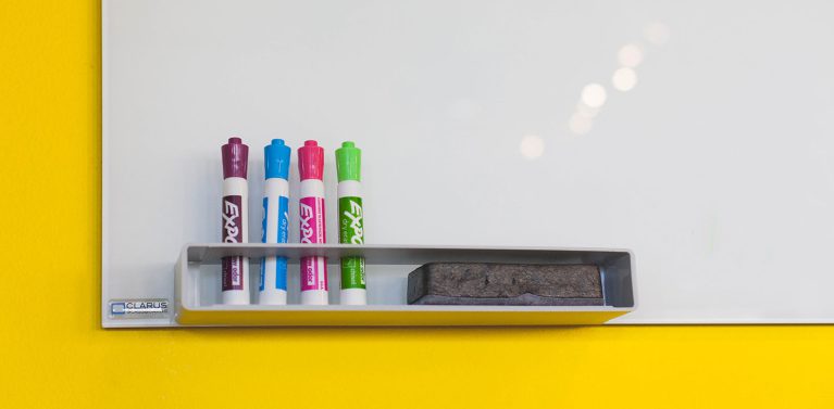 image of whiteboard pens on a whiteboard stand.