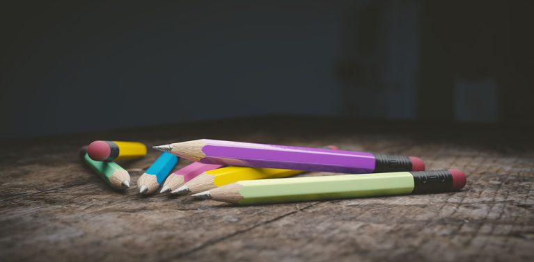 image of coloured pencils on a wooden surface.