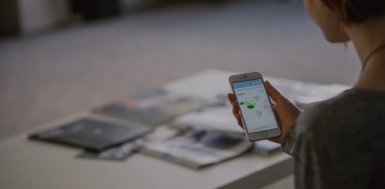 image of a woman looking at a phone.