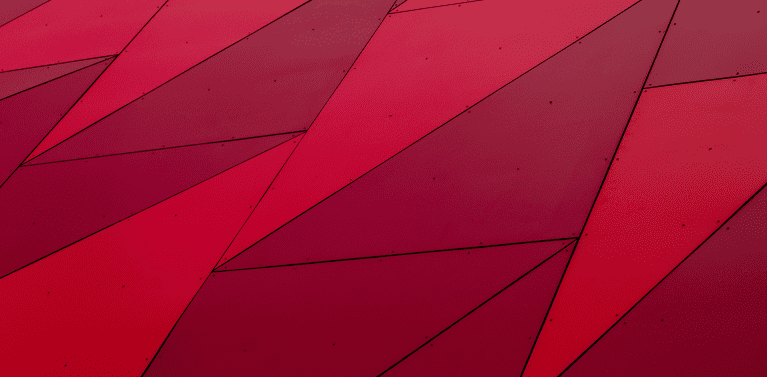 image of red triangle paneling making large squares on what looks like the exterior of a building.