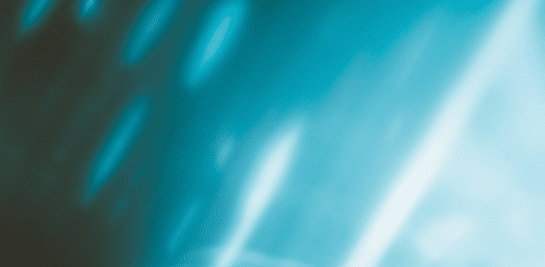 blurred image of white light on a black background with a blue tinge