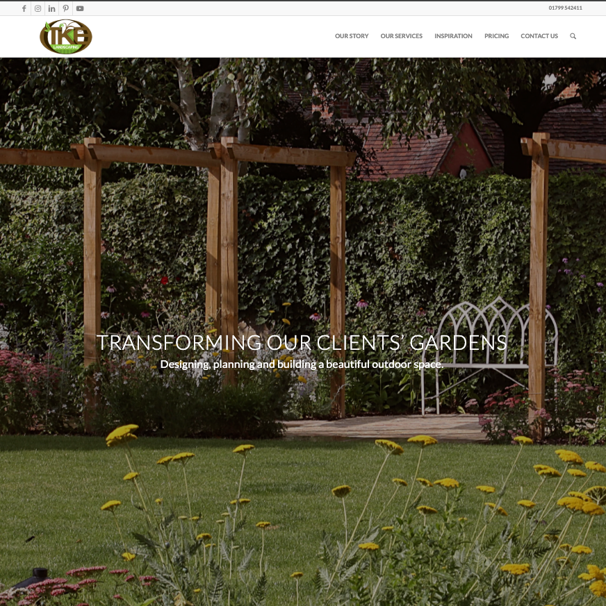 A TKE website image showing a photograph of garden with grass, a selection of colourful flowers and a white bench situated on a small decking area. An overlay of white text reads 'transforming our clients' gardens'.