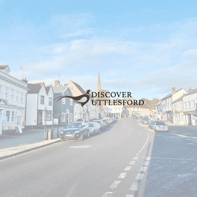 Image of Discover Uttlesford logo over the top of a photo of a town