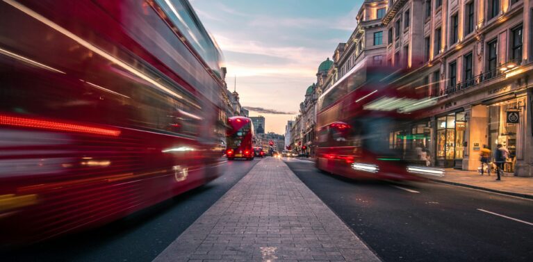 image of busses on a busy street